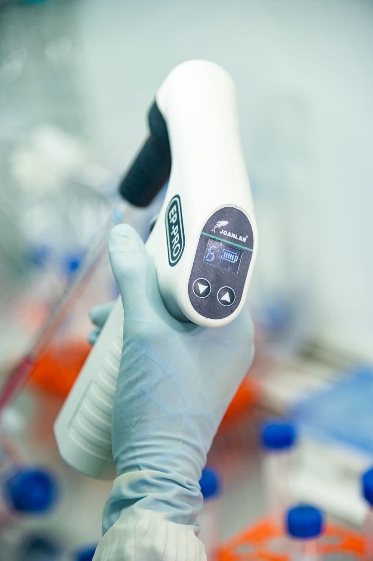 A scientist using a pipette controller in the lab